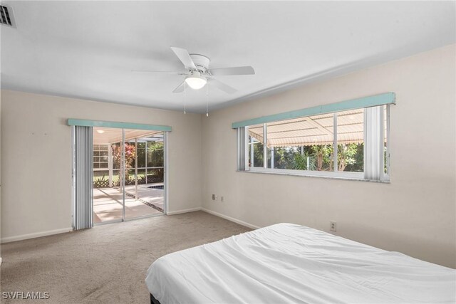 bedroom with access to outside, baseboards, multiple windows, and carpet flooring