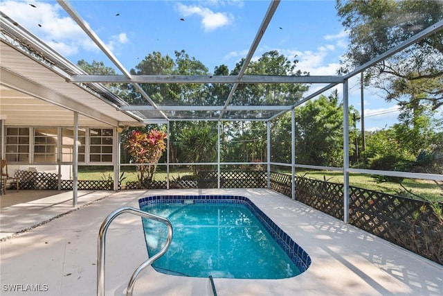 pool with a lanai and a patio area