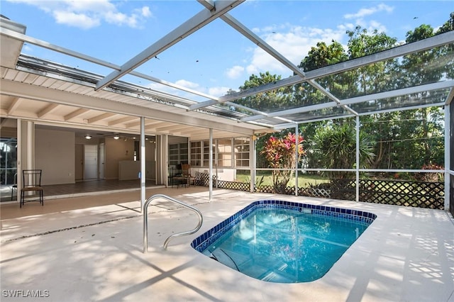 outdoor pool with a lanai and a patio