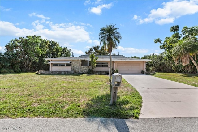 view of front facade with an attached garage, concrete driveway, and a front yard