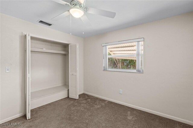 unfurnished bedroom featuring carpet floors, baseboards, visible vents, and a closet