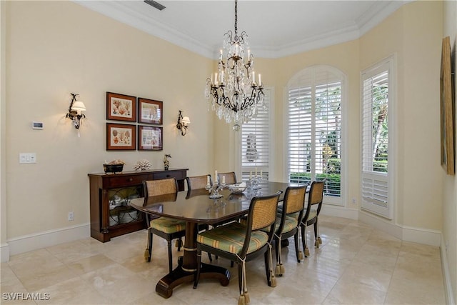 dining space featuring baseboards, visible vents, ornamental molding, and a notable chandelier