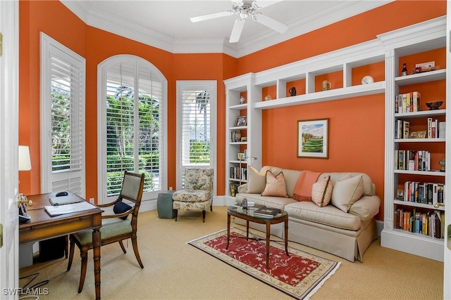 sitting room featuring ornamental molding, ceiling fan, and carpet floors