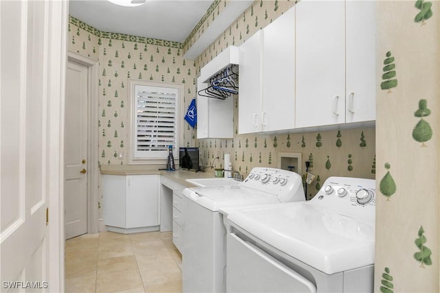 laundry area with washer and clothes dryer, light tile patterned floors, cabinet space, a sink, and wallpapered walls