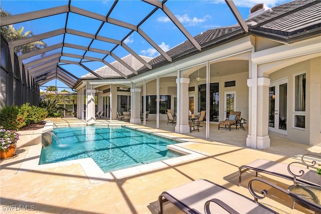 outdoor pool featuring ceiling fan, glass enclosure, french doors, and a patio area