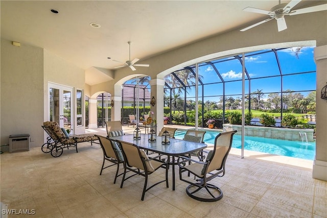 view of patio / terrace featuring a lanai, a ceiling fan, and an outdoor pool