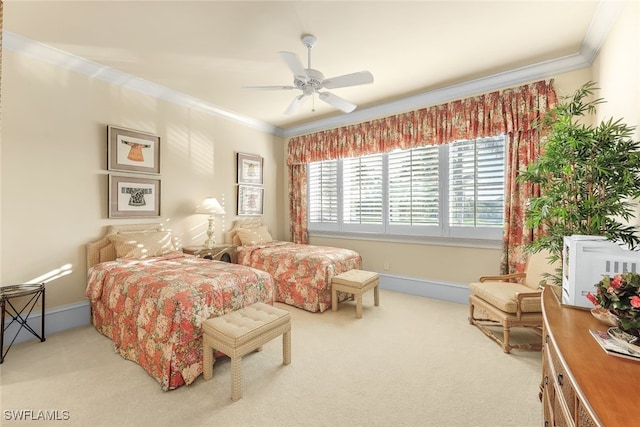 carpeted bedroom with ornamental molding and ceiling fan