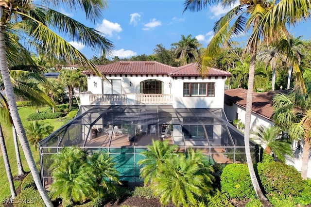 back of house with a balcony and a lanai