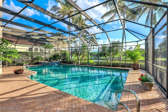 view of swimming pool with a patio and glass enclosure