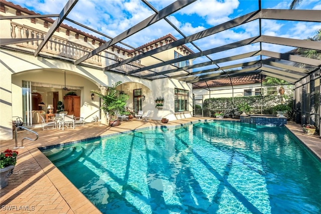 view of pool featuring a patio area and glass enclosure