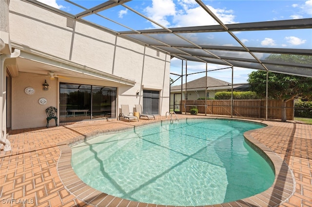 view of swimming pool featuring a lanai and a patio area