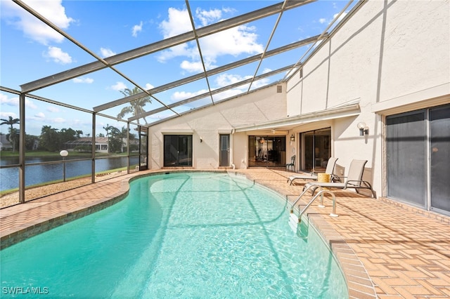 view of swimming pool featuring a water view, a lanai, and a patio