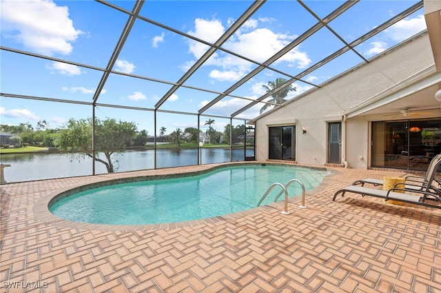 view of swimming pool featuring a water view, a patio, and a lanai