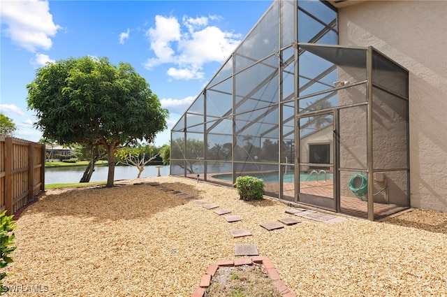 exterior space featuring a patio, a lanai, and a water view