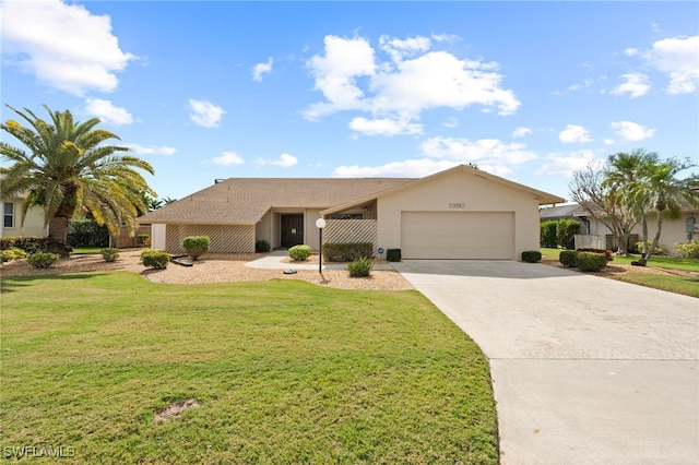 single story home with a garage and a front lawn