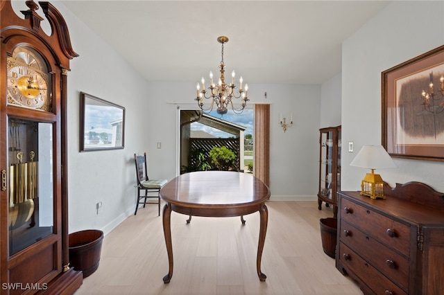 dining area featuring a chandelier and light hardwood / wood-style flooring