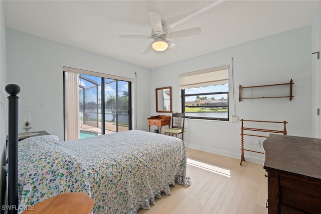 bedroom featuring access to exterior, light hardwood / wood-style floors, and ceiling fan