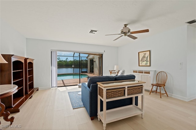 bedroom with ceiling fan, light hardwood / wood-style flooring, and access to outside