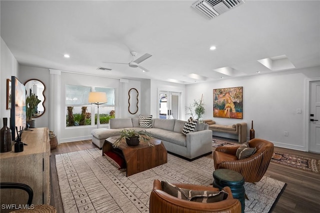 living area featuring recessed lighting, visible vents, baseboards, and wood finished floors