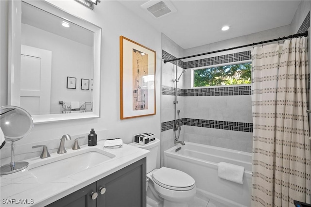 full bathroom featuring shower / tub combo, visible vents, vanity, and toilet