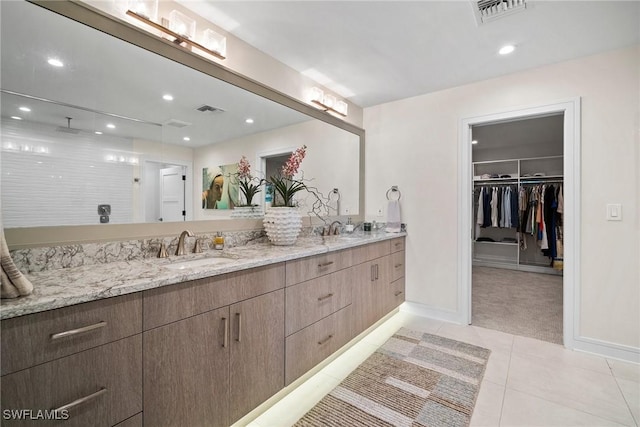 full bathroom with double vanity, visible vents, a sink, and tile patterned floors