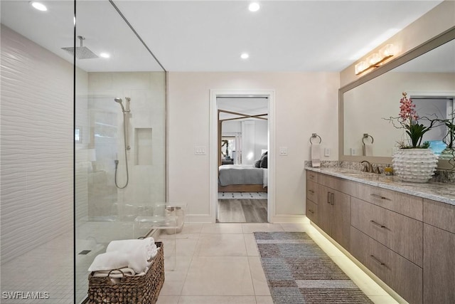 ensuite bathroom featuring tile patterned flooring, connected bathroom, vanity, visible vents, and walk in shower