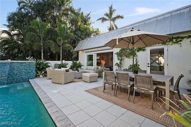 view of patio featuring outdoor dining area, outdoor lounge area, and an outdoor pool