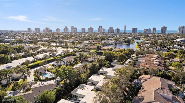 birds eye view of property featuring a city view and a water view