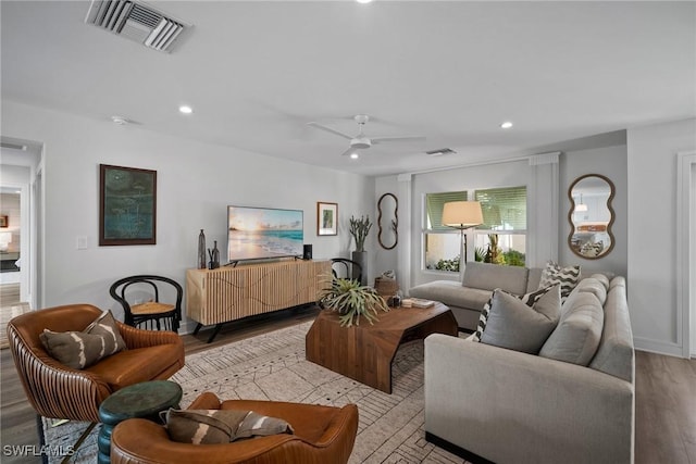 living area with ceiling fan, wood finished floors, visible vents, and recessed lighting