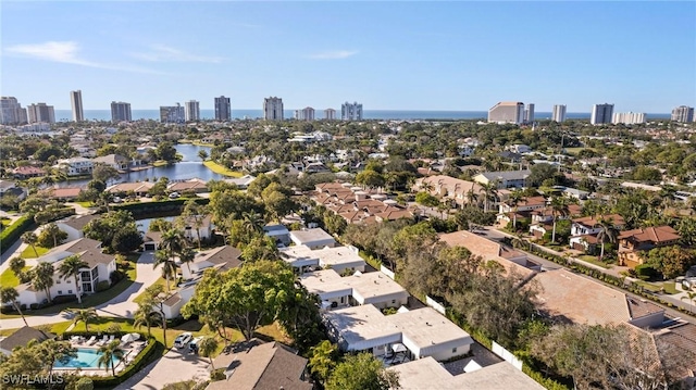 drone / aerial view featuring a city view and a water view