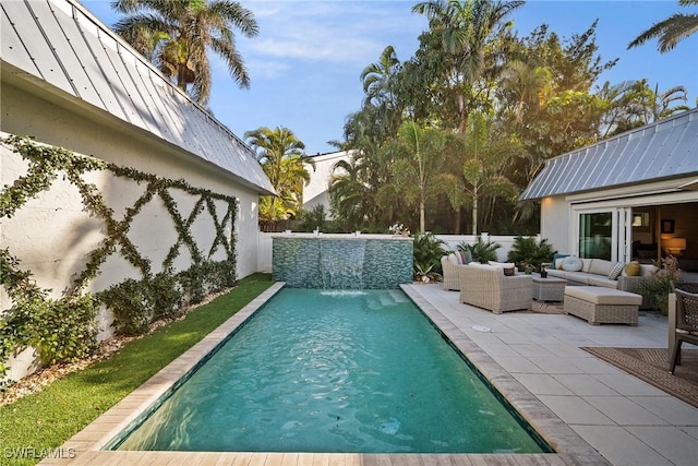 outdoor pool with a patio area, a fenced backyard, and outdoor lounge area