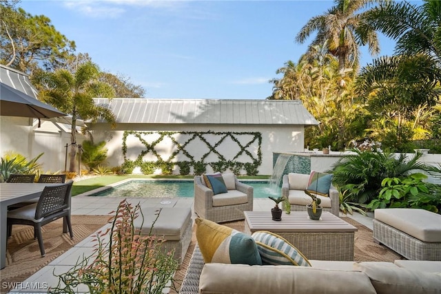 view of patio featuring a fenced backyard, an outdoor pool, and an outdoor hangout area