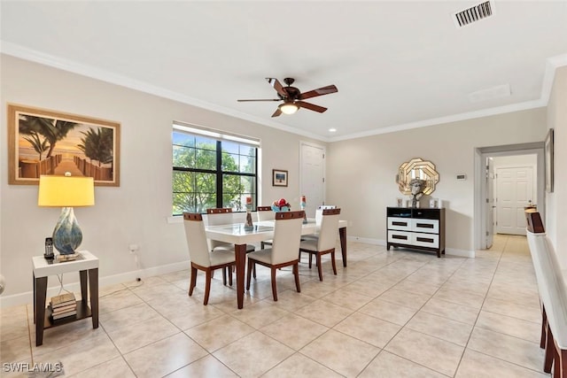 dining area with crown molding, light tile patterned flooring, and ceiling fan