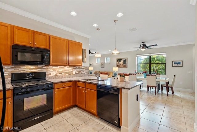 kitchen with light stone countertops, ornamental molding, black appliances, and kitchen peninsula