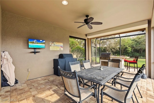 sunroom featuring ceiling fan