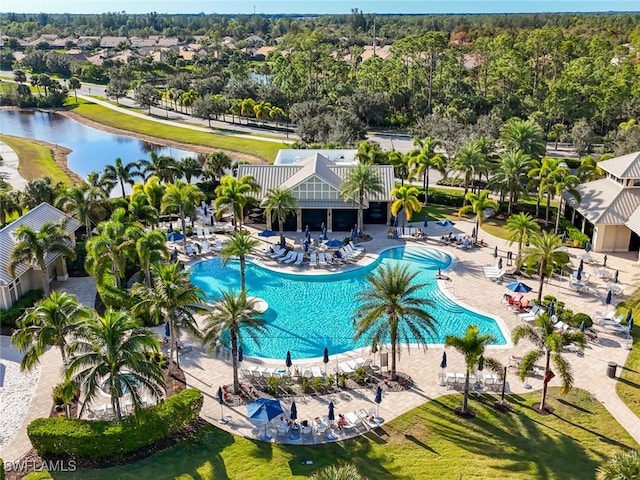 view of pool with a water view and a patio