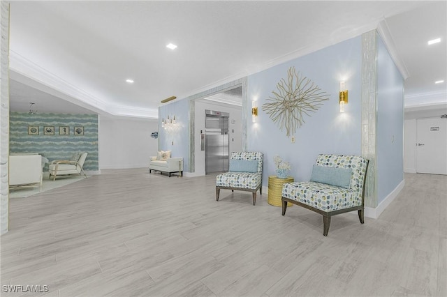 living area with ornamental molding, elevator, and light wood-type flooring