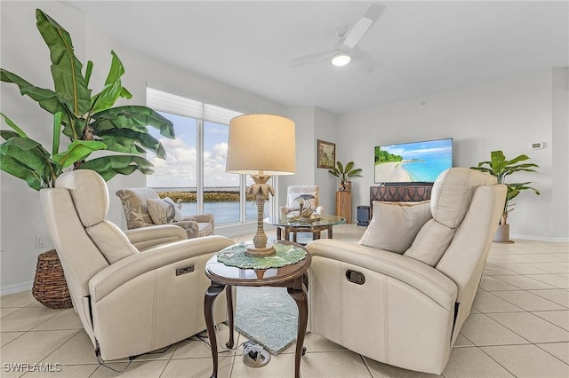 living room featuring ceiling fan and light tile patterned floors