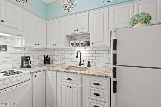 kitchen featuring white appliances, tasteful backsplash, white cabinetry, open shelves, and a sink