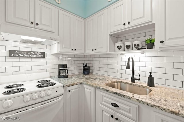 kitchen featuring white electric range, backsplash, white cabinetry, a sink, and under cabinet range hood