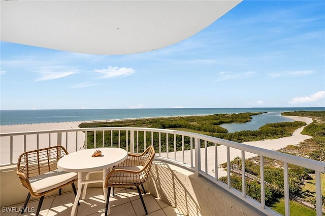 balcony featuring a beach view and a water view