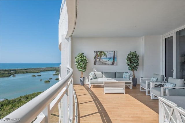 balcony with a water view and outdoor lounge area