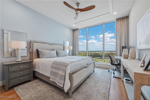 bedroom with ceiling fan and light wood-type flooring