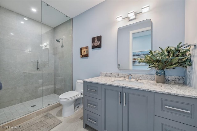 bathroom featuring walk in shower, vanity, and toilet