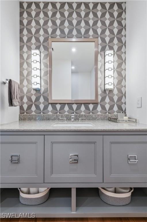 bathroom featuring vanity and decorative backsplash