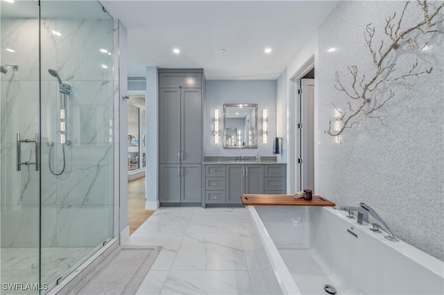 bathroom with independent shower and bath and vanity