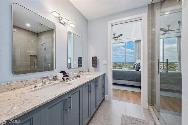 bathroom with vanity, a shower with shower door, tile patterned floors, and ceiling fan