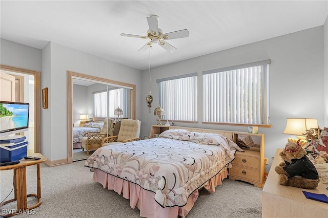 bedroom featuring baseboards, a ceiling fan, and light colored carpet