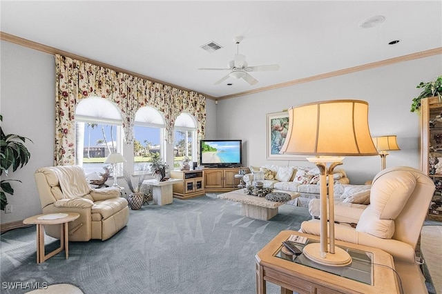 carpeted living area with a ceiling fan, visible vents, and crown molding