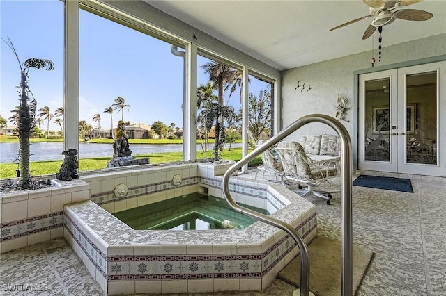 sunroom / solarium with french doors, a water view, and a hot tub